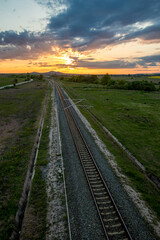Railway as seen from above, shortly before sunset, cloudy dramatic sky.