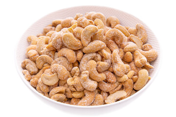 Salted cashew nuts in a white bowl close-up.isolated food products