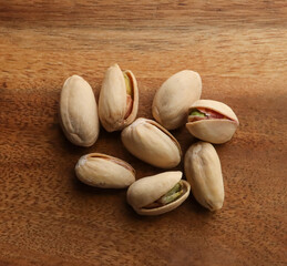 pistachio nuts on a wooden table