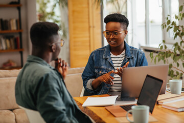 Couple using laptop at home and working