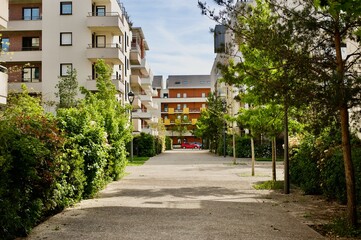 group of modern apartment buildings with quiet alleys