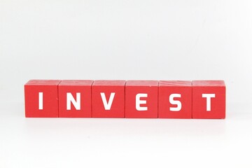 red cube with the word invest