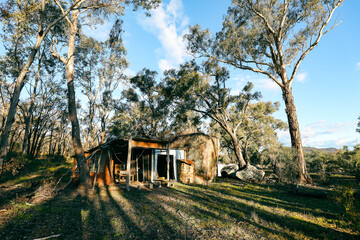 Abandoned orange bush shack nestled in the Australian bush