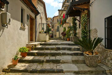 Fototapeta na wymiar Muro Lucano, Italy, June 12, 2021. A narrow street among the old houses of a medieval village in the Basilicata region.