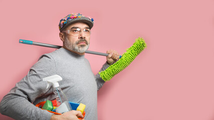 Spring cleaning funny middle aged man with a mop and wearing protective glasses - Powered by Adobe