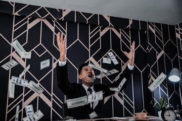 Successful businessmen celebrates success under money rain falling down dollar bills . Finances...