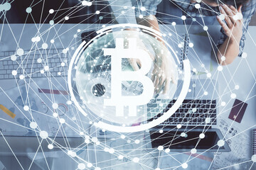 Double exposure of man and woman working together and crypto theme hologram drawing. Computer background. Blockchain concept. Top View.