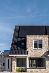 Newly build houses with solar panels attached on the roof against a sunny sky Close up of new...