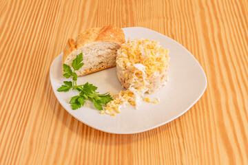 Individual tapa of Russian salad with its slice of bread