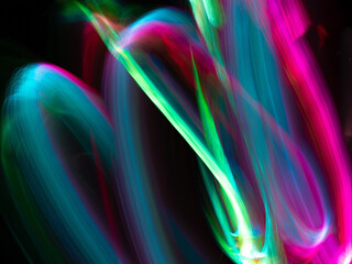 light painting photography, waves of vibrant color against a black background. Long exposure photo of vibrant fairy lights in abstract. abstract color wallpaper	