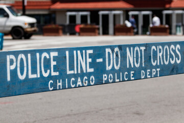 POLICE LINE DO NOT CROSS sign courtesy of the Chicago Police Department.