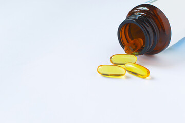 Fish oil capsules on white background and texture., Fish oil capsules and container., selective focus.