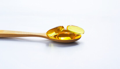 Fish oil capsules on white background and texture., Fish oil capsules and container., selective focus.