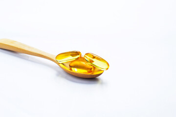 Fish oil capsules on white background and texture., Fish oil capsules and container., selective focus.