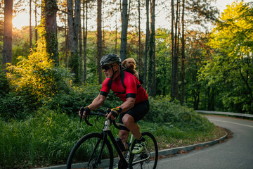 Fototapeta premium Senior man cycling with his puppy