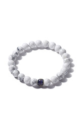 Detail shot of beaded bracelet made of white marble and decorated with blue cat eye bead. Stylish bracelet is isolated on the white background. 