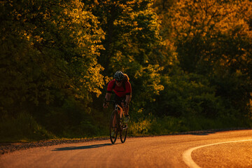 Fototapeta premium Bicycle rider pedaling on a country road