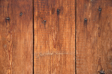 Naklejka premium bright brown wooden fence with old nails
