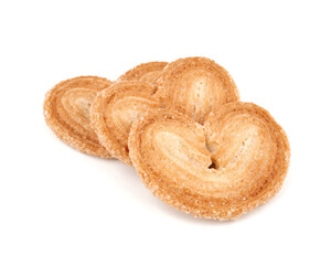 Puff pastry cookies. Fresh puff pastry cookies in the shape of a heart. Classic French pastries. Pig ear, elephant ear cookies, French hearts. Heart shaped puff pastry isolated on white background