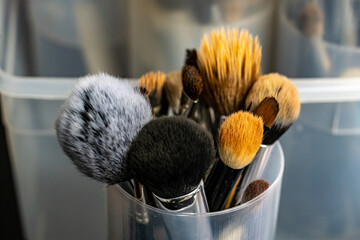Closeup of a set of makeup brushes on a plastic holder
