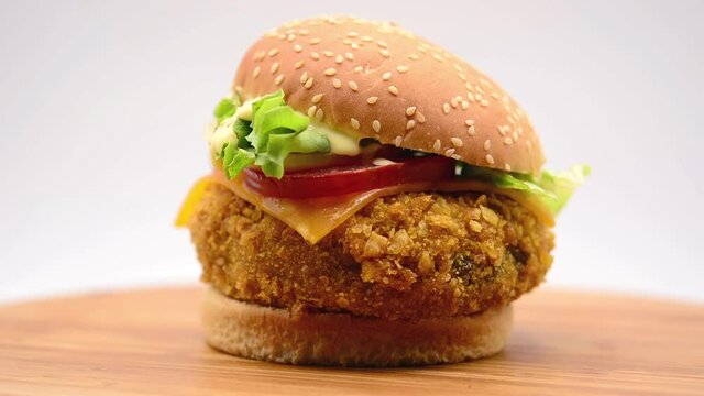 Crispy chicken burger footage rotating on white background