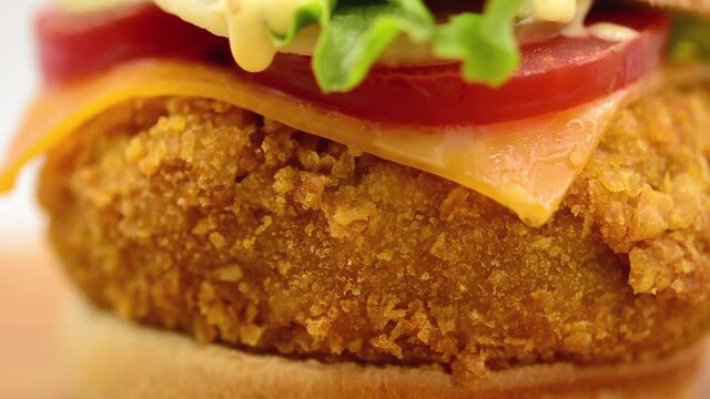 Crispy chicken burger footage rotating on white background