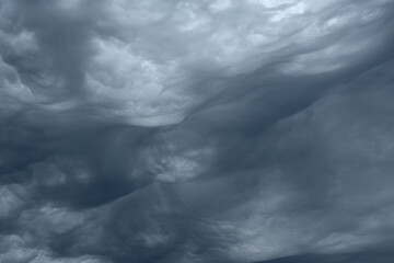 Blue and dark grey heavy clouds in the sky before a thunderstorm. Dramatic backdrop or wallpaper....