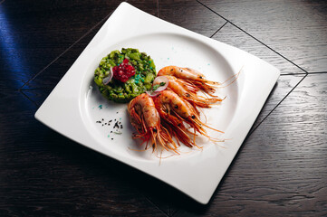 shrimps and avocado salad on white plate