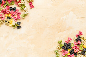 Frame of pasta - flay lay of Italian colorful farfalle, top view
