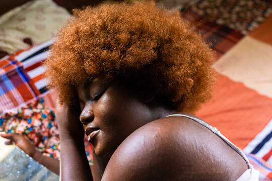 Woman With Her Eyes Close On Her Bed.