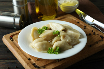 Concept of tasty food with vareniki or pierogi on wooden table