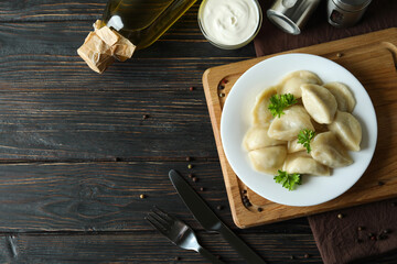 Concept of tasty food with vareniki or pierogi on wooden table
