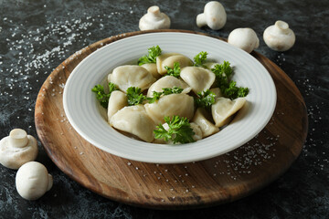 Concept of tasty food with vareniki or pierogi on dark table