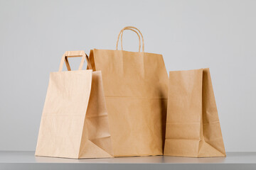 Brown paper bag with handles, empty shopping bag with area for your logo or design, food delivery...