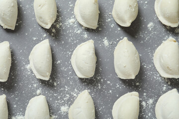 Concept of cooking vareniki or pierogi on gray background