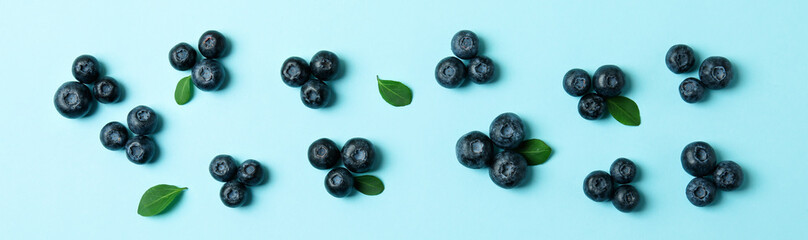 Fresh blueberry with leaves on blue background
