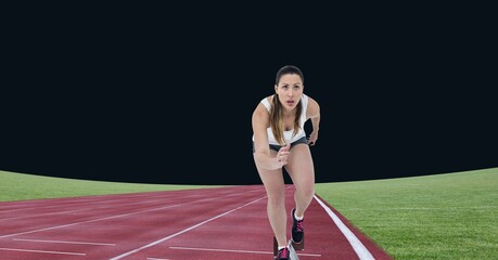 Obraz premium Caucasian female athlete running on sports field against black background
