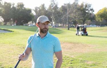 portrait of golfer in cap with golf club looking away. people lifestyle. man playing game