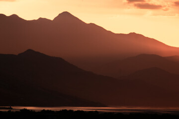 Mountains shape at sunset sky. Relaxing mountain landscape with colorful sunset, nature outdoor travel background.