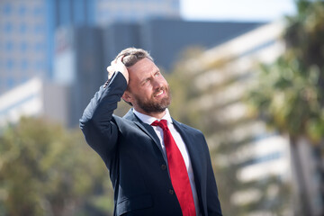 bearded businessman looking up on urban background, business man.