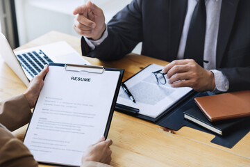 Examiner reading a resume during job interview at office