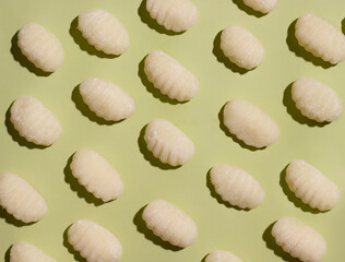 Italian food. Gnocchi traditional dish pattern on green background