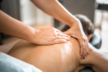 Obraz na płótnie Canvas Deep tissue massage closeup view. Massage closeup with hands of professional masseur. Spa and job concept.