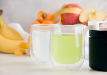 White and green fitness drinks on light background