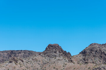 Fototapeta na wymiar Barren rocky desert mountain under a blue sky
