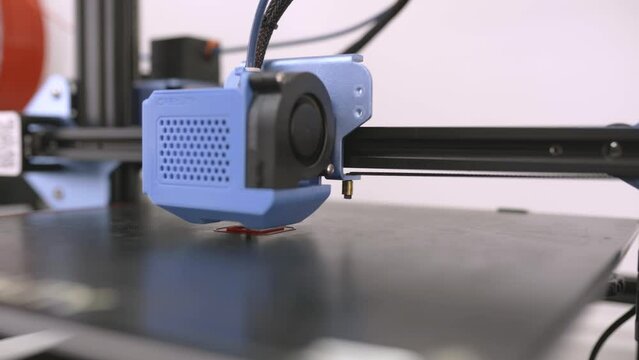 Stock video of modern 3d printer printing cool red design.