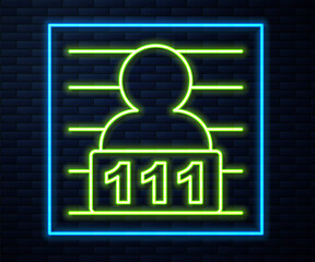 Glowing neon line Suspect criminal icon isolated on brick wall background. The criminal in prison, suspected near the board. Vector