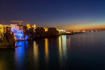 Obraz premium Polignano at sea at night, Immediately after sunset, a village by the sea in Bari in Puglia