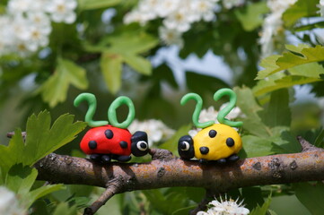 Figurines of two ladybirds made of plasticine. At the top is the calendar date 2022.
