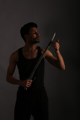Fototapeta premium A man with long knife in shadows